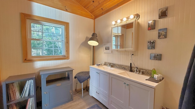 bathroom with vanity, wood-type flooring, wooden ceiling, lofted ceiling, and wood walls