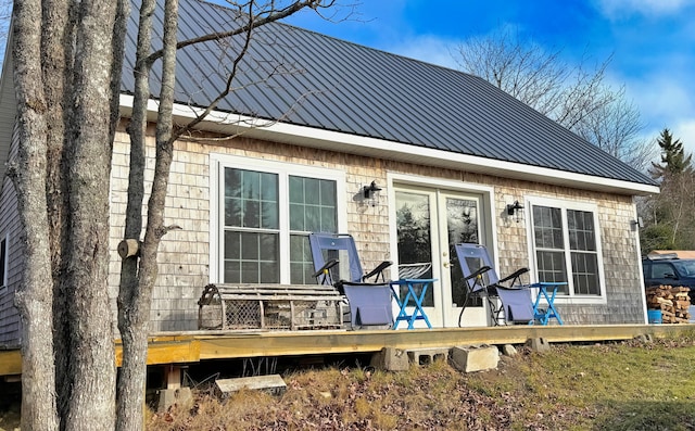 rear view of property featuring a wooden deck