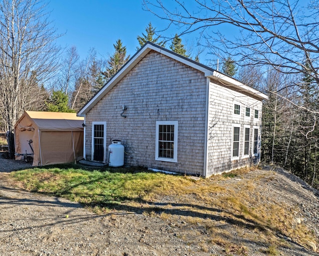 view of side of home featuring an outbuilding and a garage