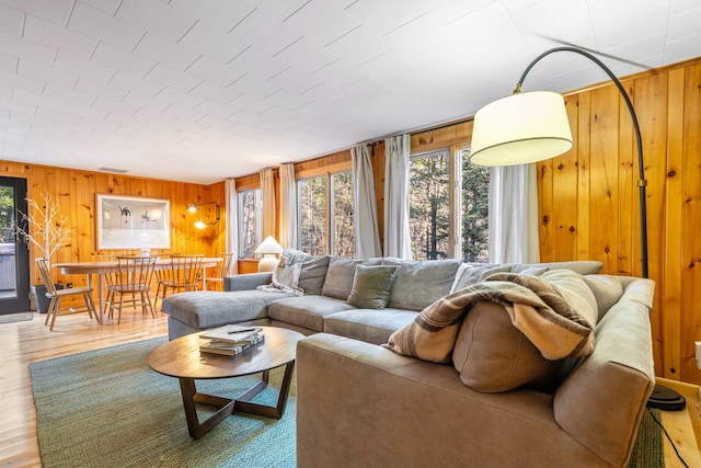 living room with wooden walls and hardwood / wood-style flooring