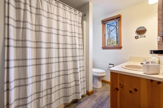 bathroom featuring hardwood / wood-style floors, vanity, and toilet