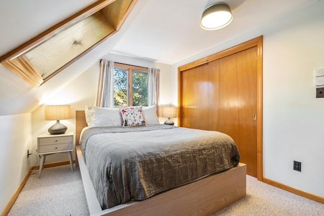 carpeted bedroom with a closet and lofted ceiling