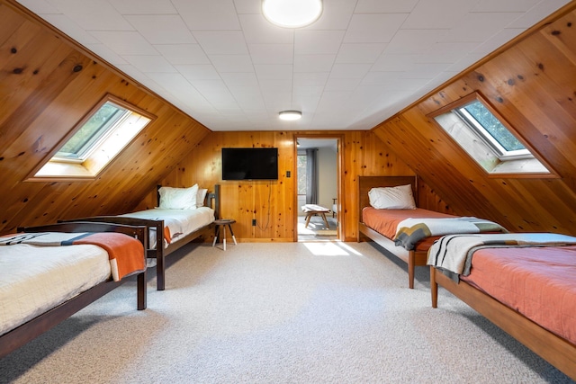 bedroom featuring lofted ceiling with skylight, light carpet, wooden walls, and multiple windows