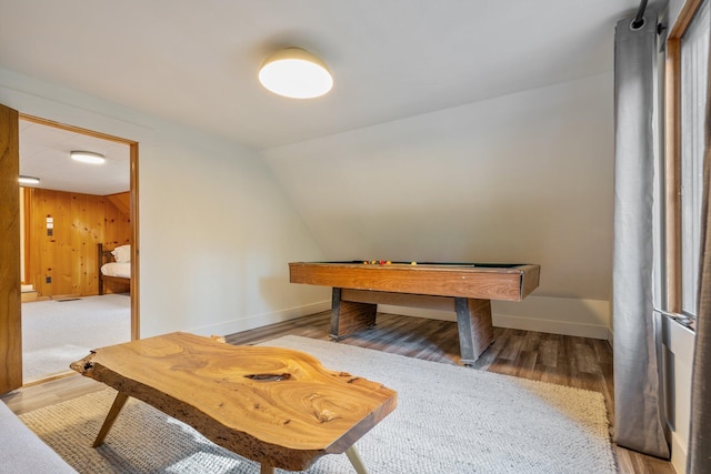 playroom with pool table, light hardwood / wood-style floors, lofted ceiling, and wooden walls