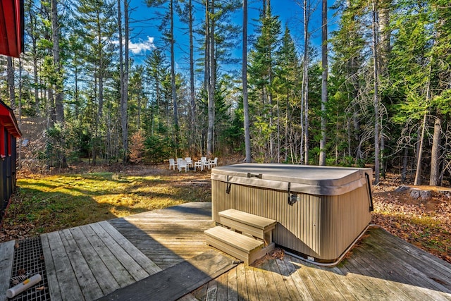 wooden deck with a hot tub