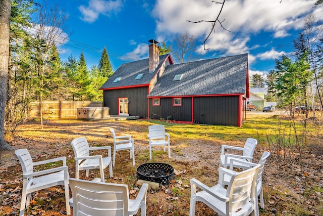 back of house with an outdoor fire pit