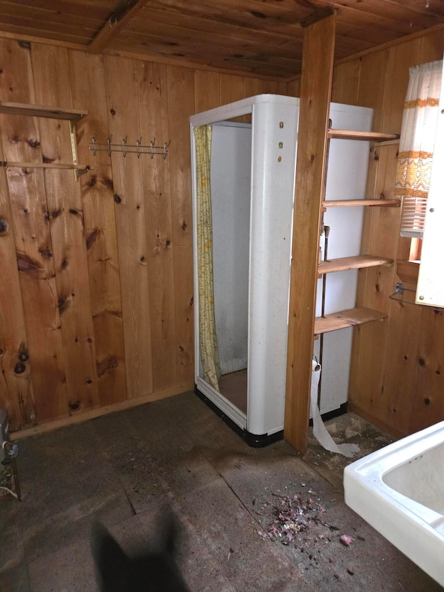 bathroom featuring wood walls and wood ceiling