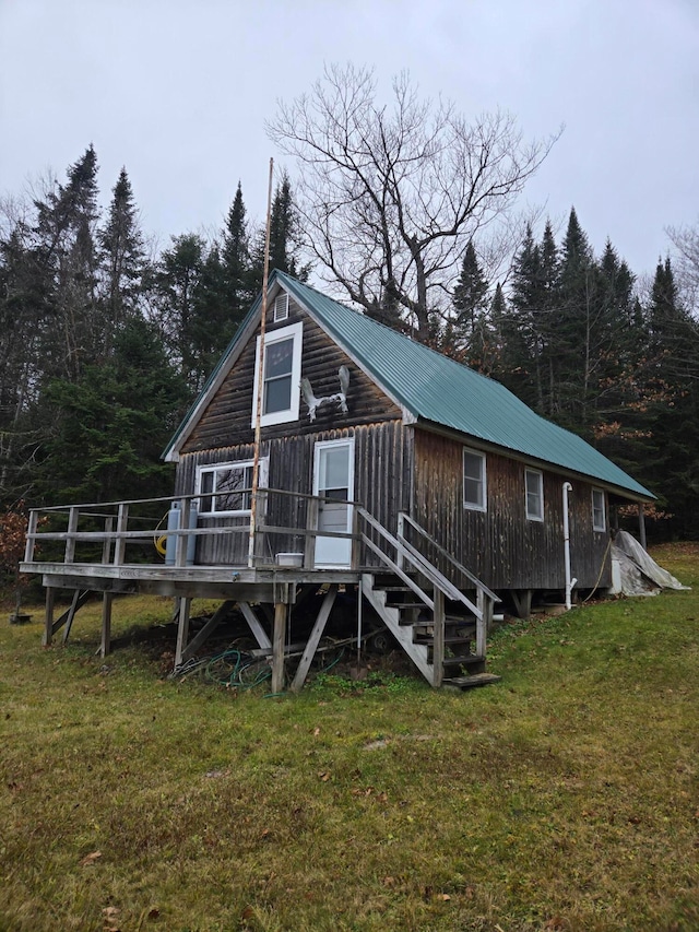 rear view of property with a lawn and a deck