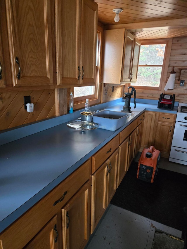 kitchen with wood walls, white range oven, and wood ceiling