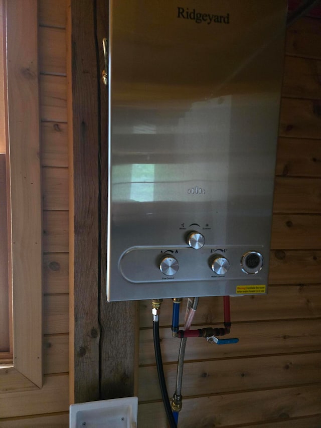 details featuring wood walls and water heater