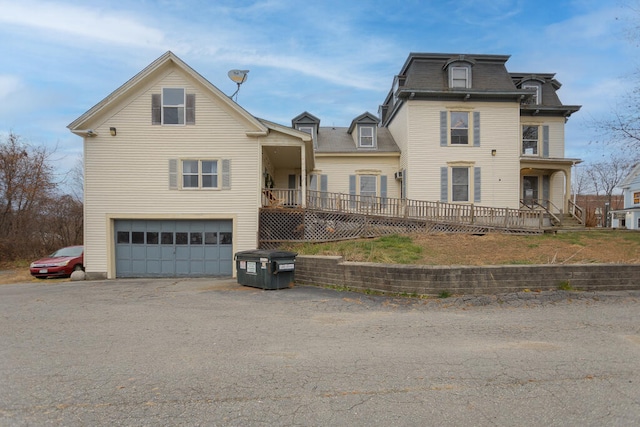 view of property featuring a garage and a deck