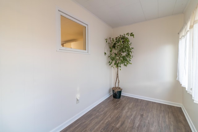 unfurnished room with dark hardwood / wood-style flooring