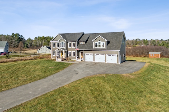 view of front of house with a garage and a front lawn