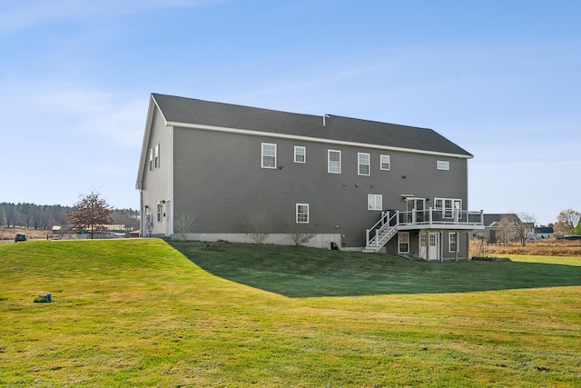 back of property with a deck and a lawn