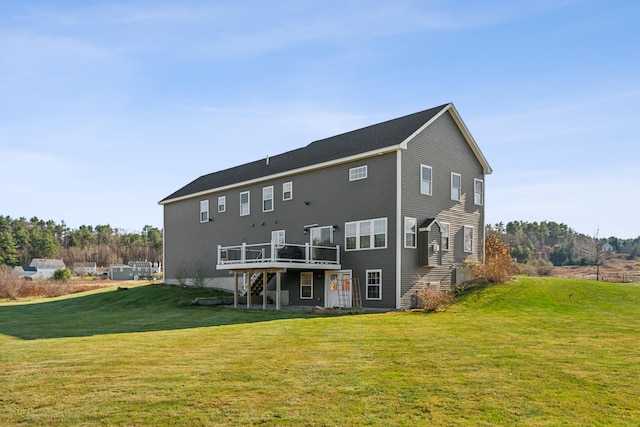 back of house featuring a wooden deck and a yard