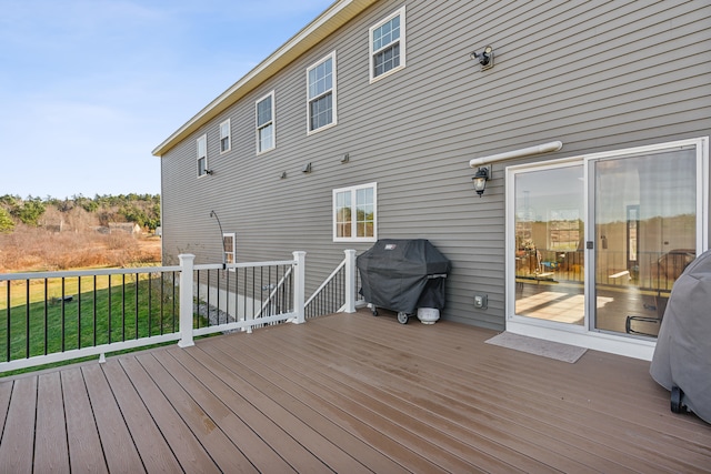 deck featuring area for grilling and a yard