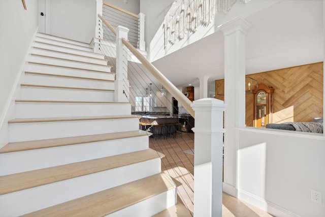 stairs with wooden walls and decorative columns