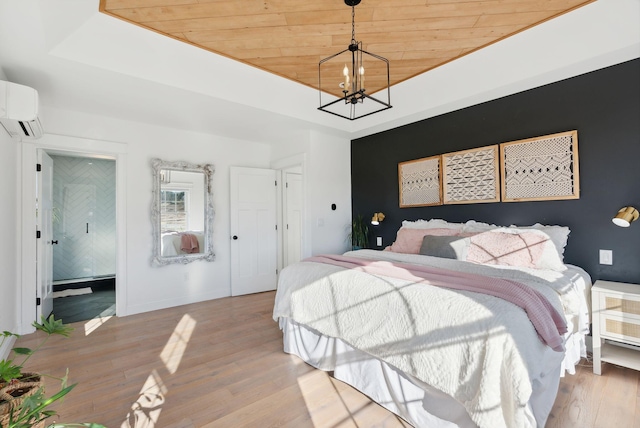 bedroom with a tray ceiling, a wall unit AC, wooden ceiling, a notable chandelier, and light hardwood / wood-style floors