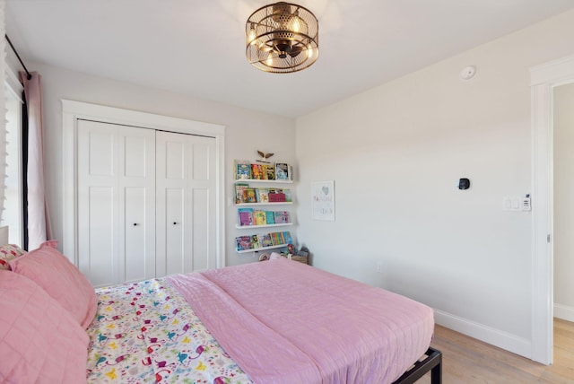 bedroom featuring light wood-type flooring and a closet