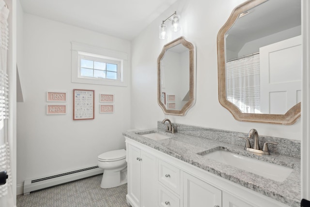 bathroom with baseboard heating, tile patterned floors, vanity, and toilet