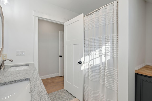 bathroom with vanity and hardwood / wood-style flooring