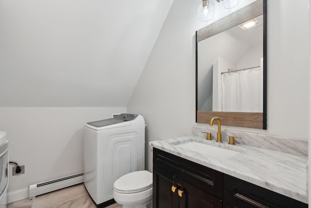 bathroom featuring vanity, baseboard heating, washer / dryer, toilet, and lofted ceiling