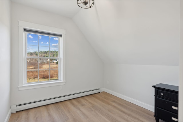 bonus room with baseboard heating, light hardwood / wood-style floors, and vaulted ceiling