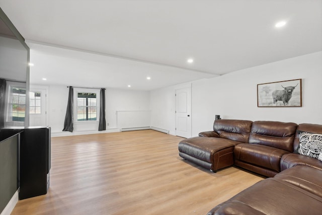 living room with light hardwood / wood-style flooring and a baseboard heating unit