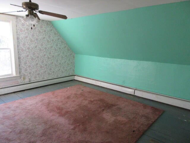 bonus room featuring a healthy amount of sunlight and vaulted ceiling