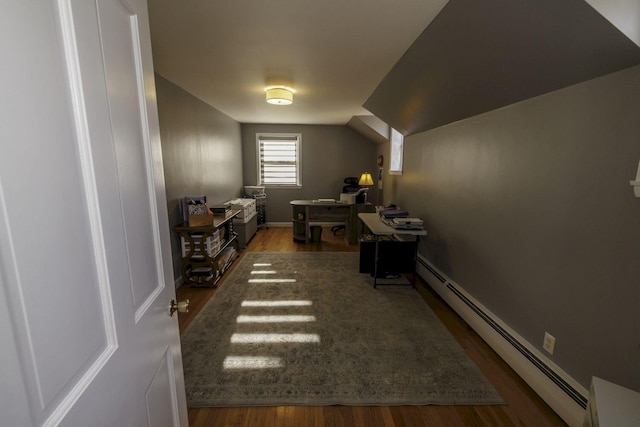 home office featuring lofted ceiling, dark hardwood / wood-style floors, and a baseboard heating unit