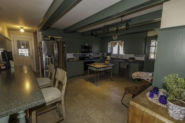 kitchen featuring beam ceiling, stainless steel appliances, gray cabinets, and sink