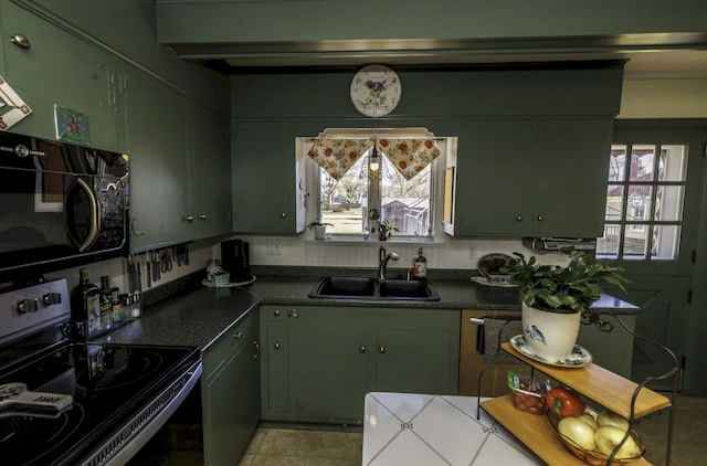 kitchen featuring light tile patterned flooring, electric range, green cabinets, and sink