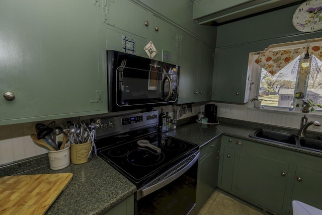 kitchen with stainless steel electric stove, sink, and green cabinetry