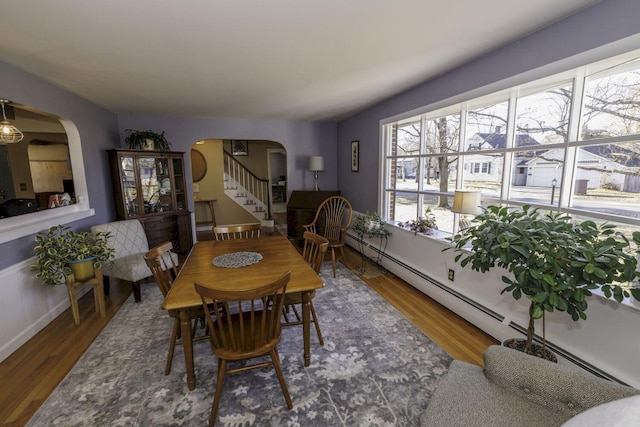 dining area with hardwood / wood-style flooring and a baseboard radiator