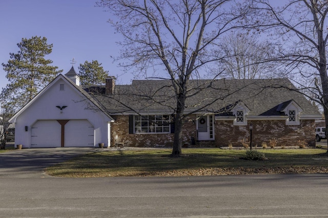 view of front of property with a garage and a front lawn