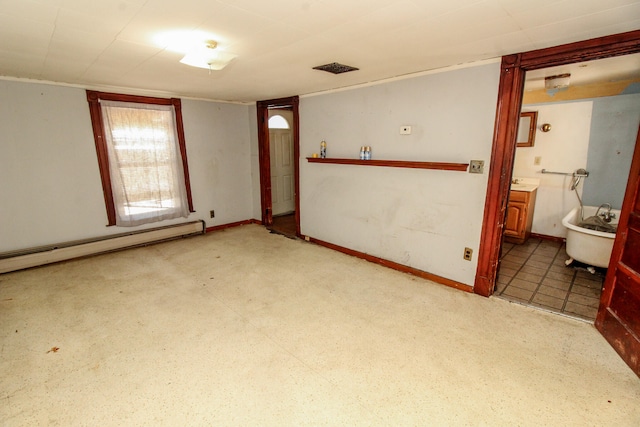 unfurnished room with a baseboard heating unit