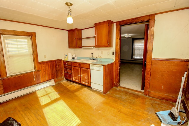 kitchen with white dishwasher, sink, decorative light fixtures, a baseboard radiator, and light hardwood / wood-style floors