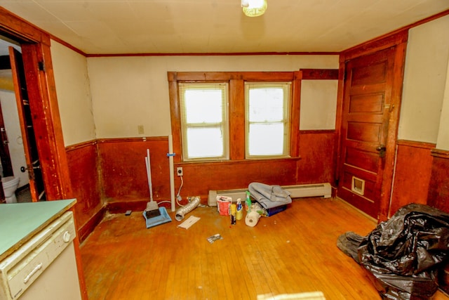 miscellaneous room featuring a baseboard heating unit and light hardwood / wood-style flooring