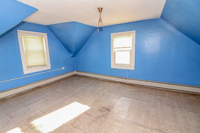 bonus room with lofted ceiling and carpet floors