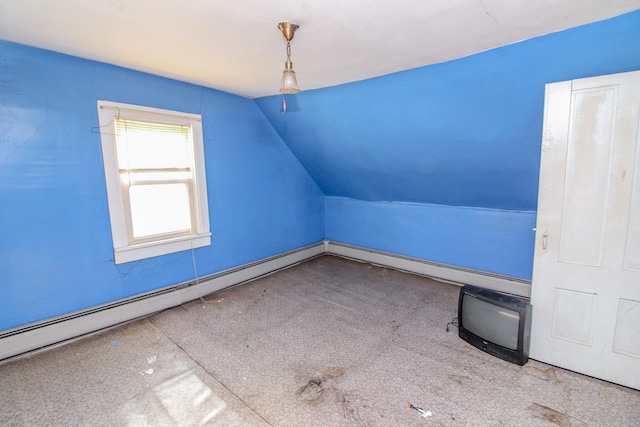 additional living space featuring baseboard heating and lofted ceiling