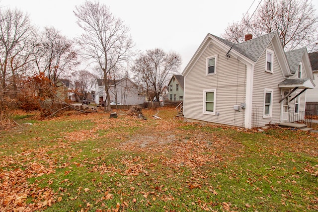 view of side of home with a lawn