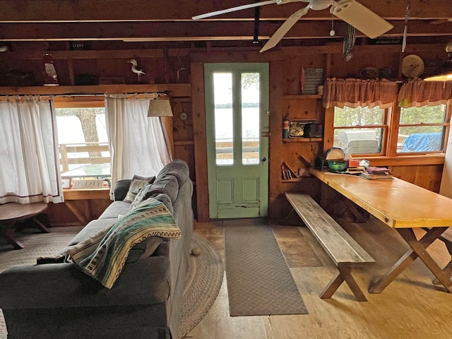 dining room with ceiling fan, plenty of natural light, and wood-type flooring