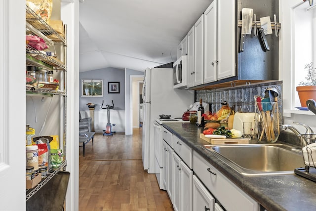 kitchen featuring sink, dark hardwood / wood-style flooring, white range, lofted ceiling, and white cabinets