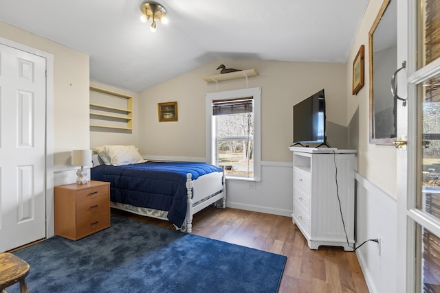 bedroom with vaulted ceiling and dark hardwood / wood-style floors