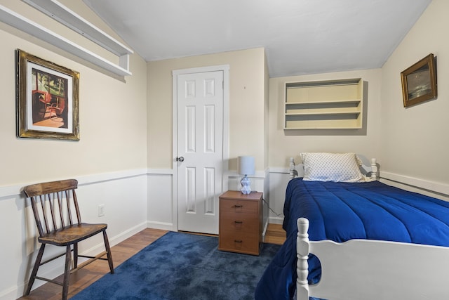 bedroom with dark wood-type flooring and vaulted ceiling