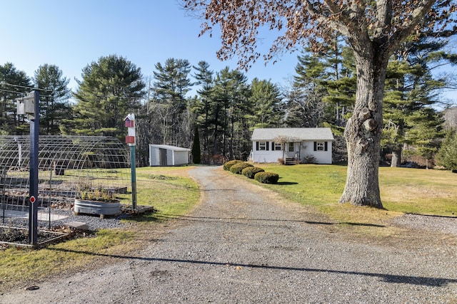 view of front of home with a front lawn and an outdoor structure