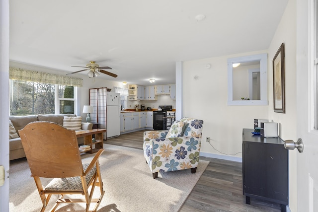 living room featuring dark hardwood / wood-style floors and ceiling fan