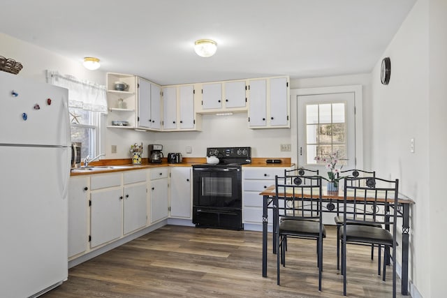 kitchen with dark wood-type flooring, white cabinets, sink, electric range, and white fridge