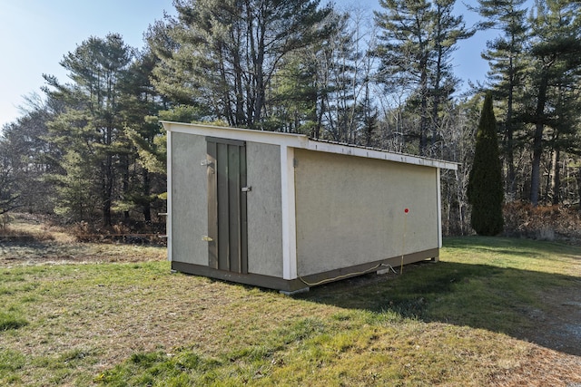 view of outbuilding featuring a yard