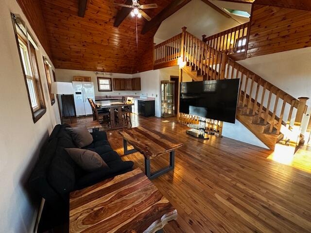 living room with wood-type flooring, high vaulted ceiling, and ceiling fan